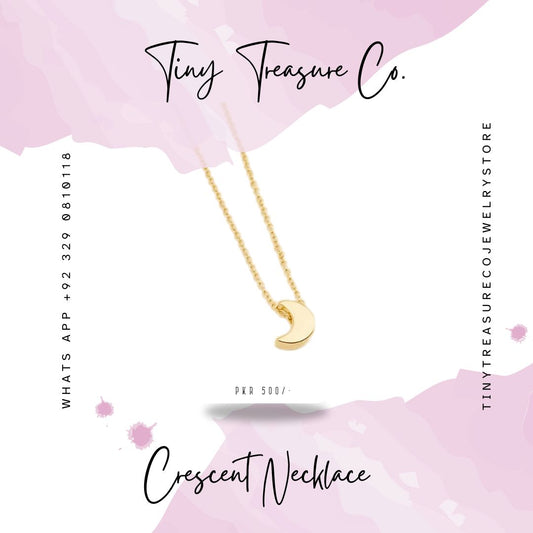 Gold crescent necklace on a pink background with 'Tiny Treasure Co.' branding. Buy the latest variety of kids jewelry online in Pakistan including necklaces, bangles, jewelry sets, rings & other hair ornaments. Shop Now!
