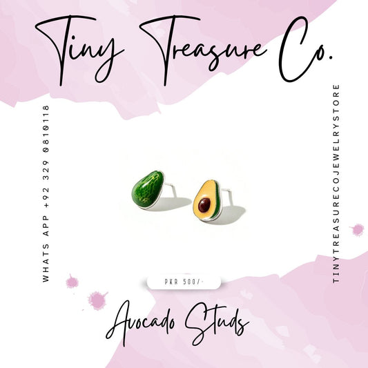 Avocado-shaped studs earrings on a pink background with 'Tiny Treasure Co.' branding. Kids Jewelry, artificial Jewelry, Unique Jewelry, most demanding, elegant, graceful, in Pakistan Karachi, Lahore, Islamabad
