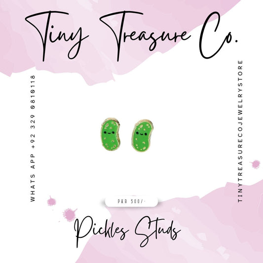 Green pickle-shaped earrings on a pink and white background with 'Tiny Treasure Co.' branding. Kids Jewelry, artificial Jewelry, Unique Jewelry, most demanding, elegant, graceful, in Pakistan Karachi, Lahore, Islamabad