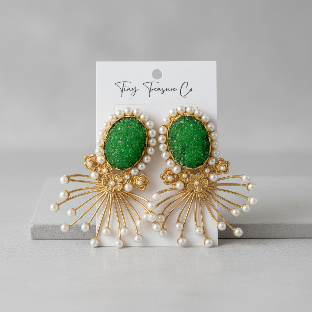 Green earrings with gold and pearl details on a 'Tiny Treasure Co.' card.