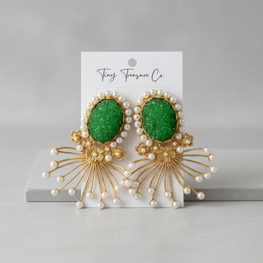 Green earrings with gold and pearl details on a 'Tiny Treasure Co.' card.