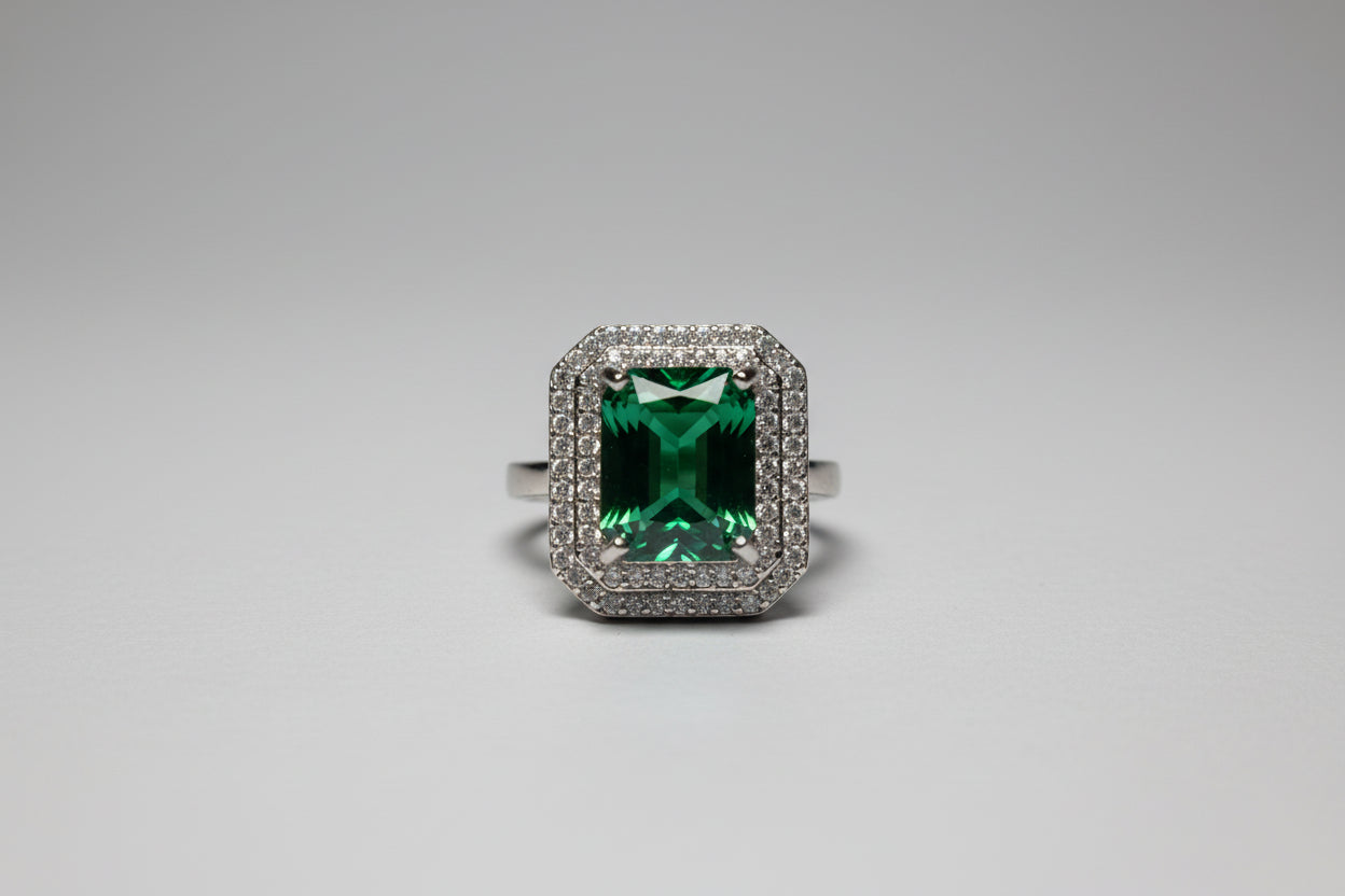 Ring with a green gemstone on a dark surface