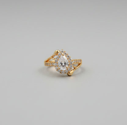 Gold ring with a diamond on a reflective surface