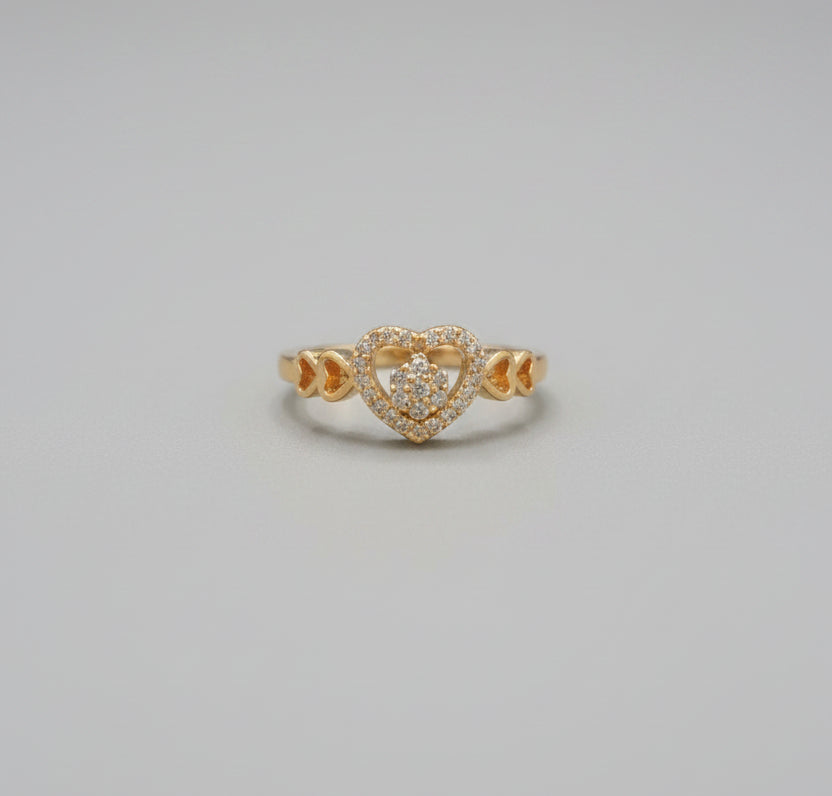 Gold ring on a reflective surface with a blurred background