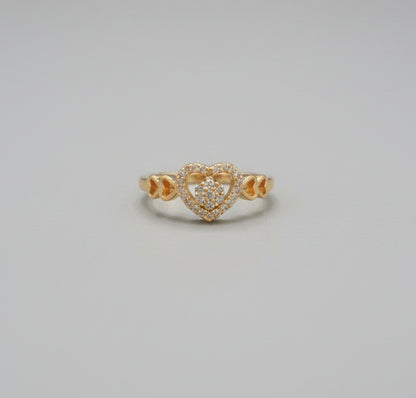 Gold ring on a reflective surface with a blurred background