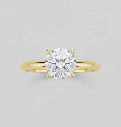 Gold ring with a diamond on a reflective surface