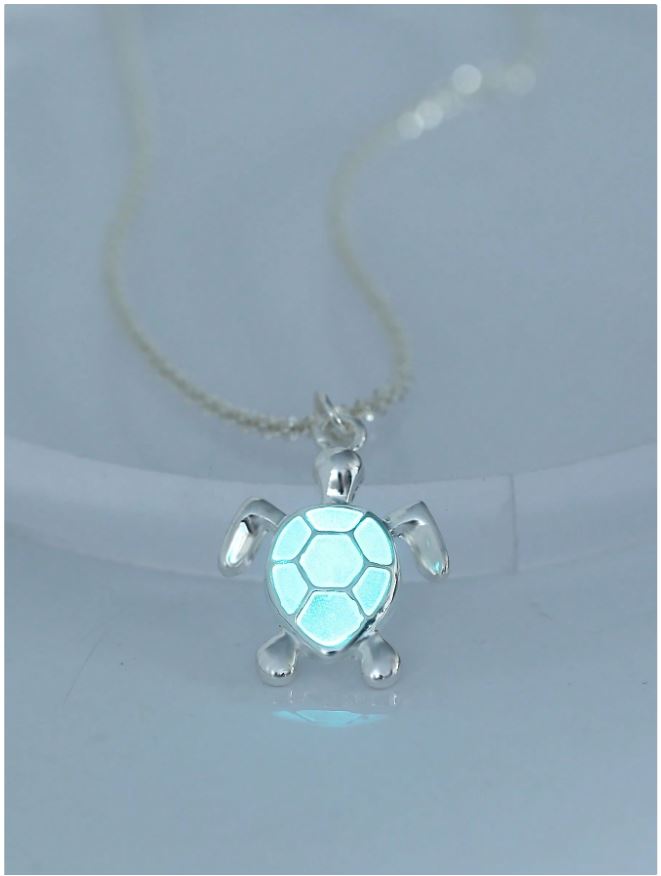 Turtle-shaped pendant with a glowing blue center on a white background